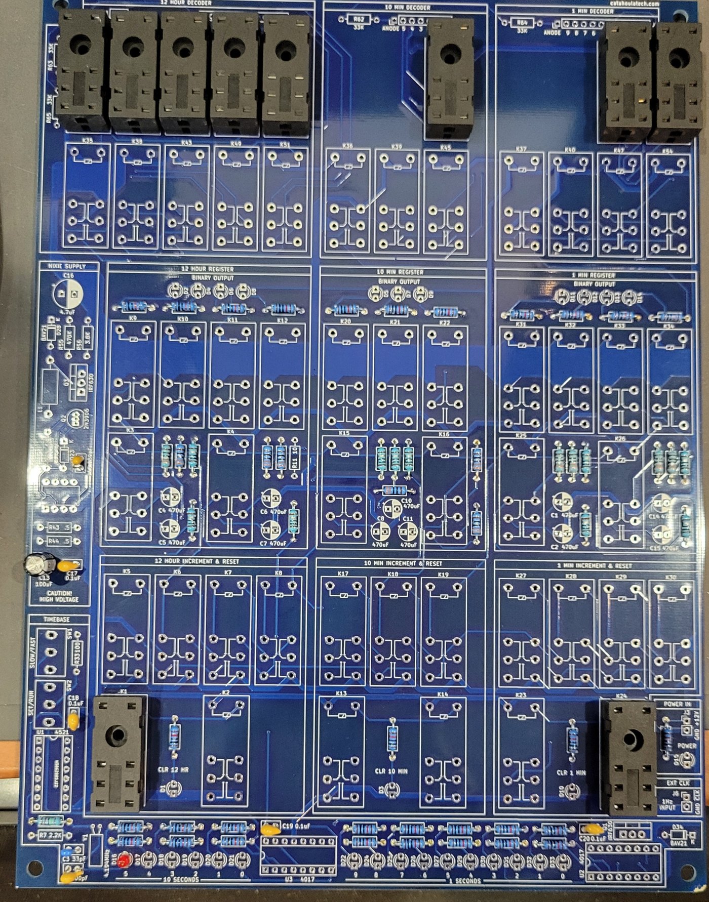 Figure 4 — My board at 13:23 on 2026-10-28: most resistors and the small capacitors fitted, ten relay sockets test-fitted across the decoders and at K1 and K24, and the NIXIE SUPPLY strip waiting…