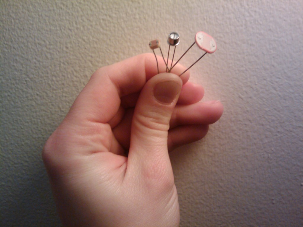 Figure 6 — 7 — Cadmium-sulphide light-dependent resistors (photoresistors) — the classic two-leaded "squiggle" sensor whose resistance falls in bright light. One of these in a divider with the build'…
